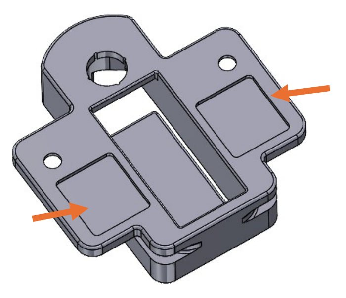 Underside of the V-Turm Mount with arrows pointing to the two recessed tape pockets